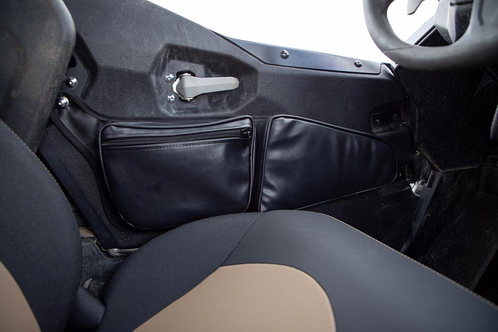 The storage bag and kneepad fit neatly in the space between the driver's seat and the door.
